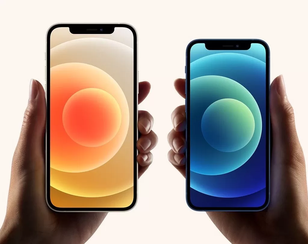 Two hands of a man holding iphone 12 and iphone 12 mini