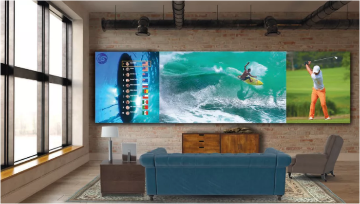 A big screen led mounted to the wall and a sofa is available in from of it