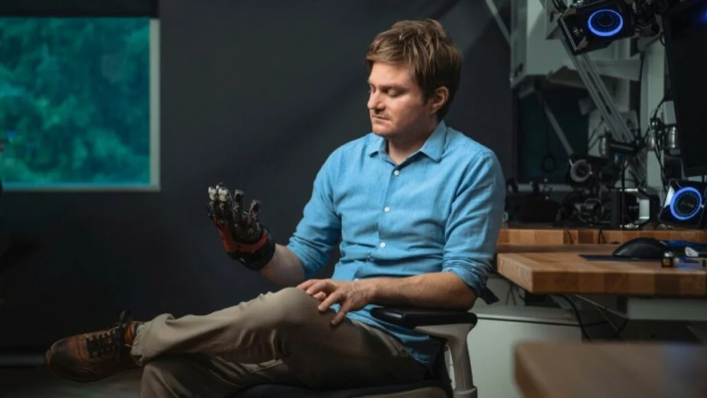 A man is wearing Haptic Glove that feels the object in VR and AR