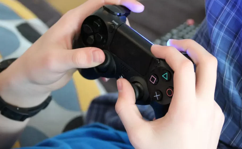 A boy is playing game with joystick