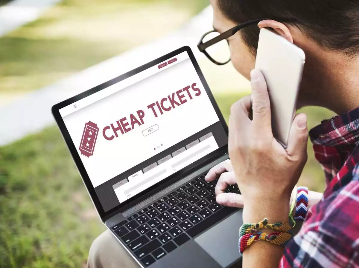 A Man is buying travelling ticket online