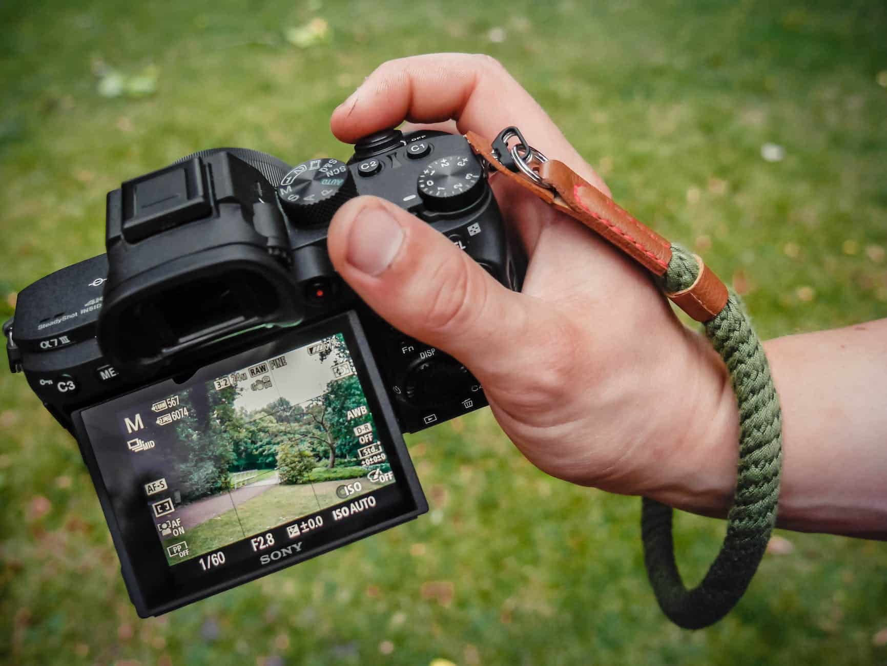 close up photo of person holding black camera