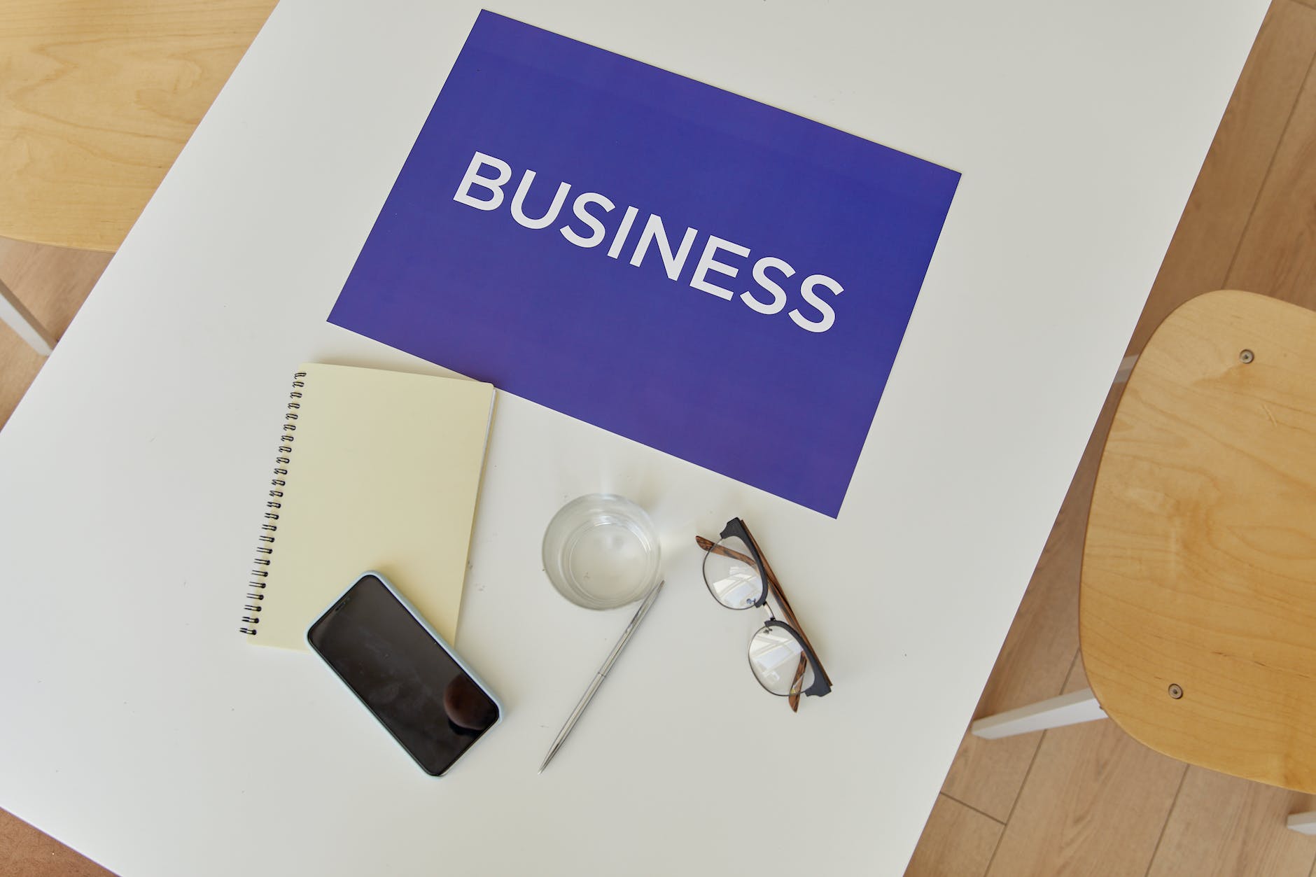 notebook glasses and phone lying on table - b2b marketing