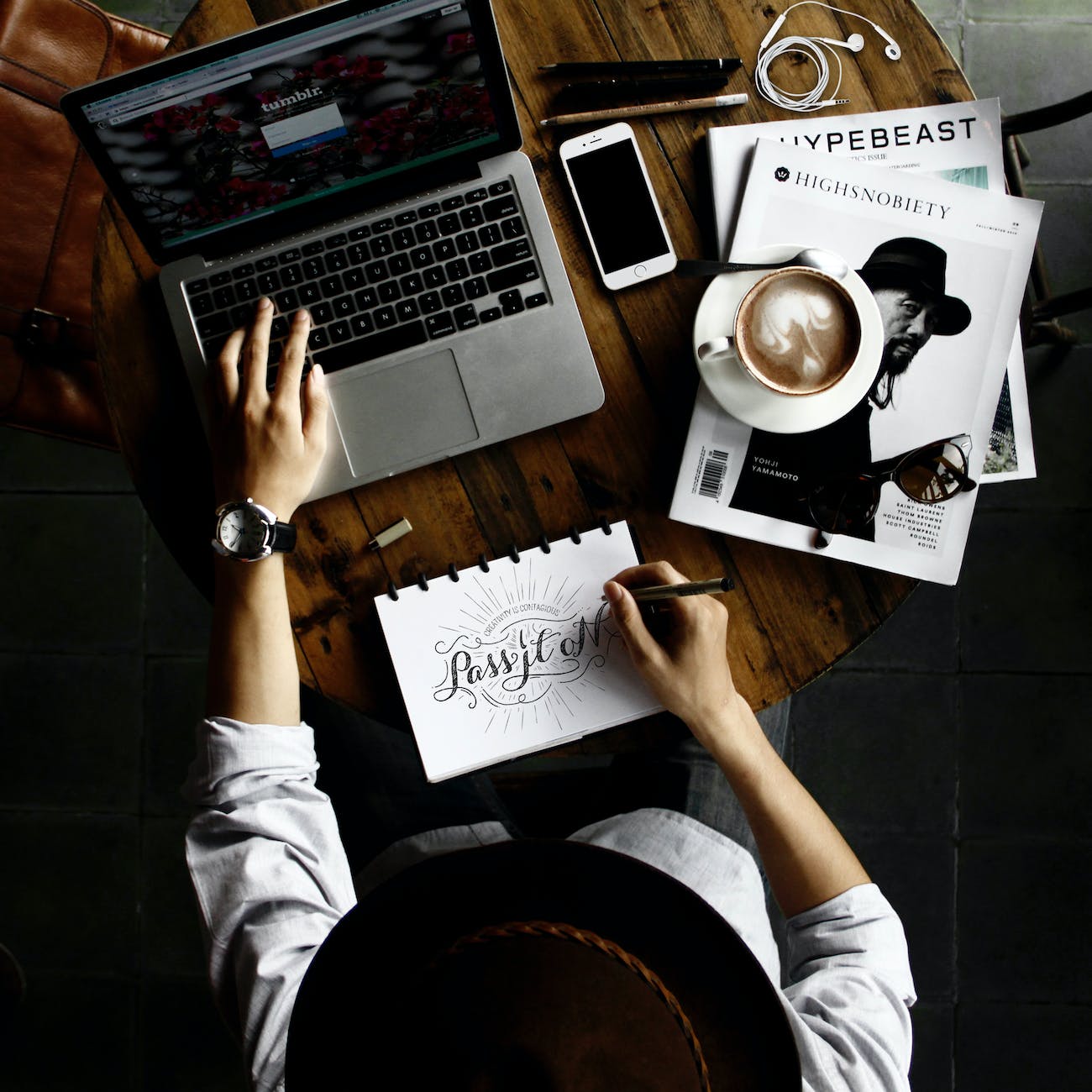 person sitting facing laptop computer with sketch pad - Website Maintenance