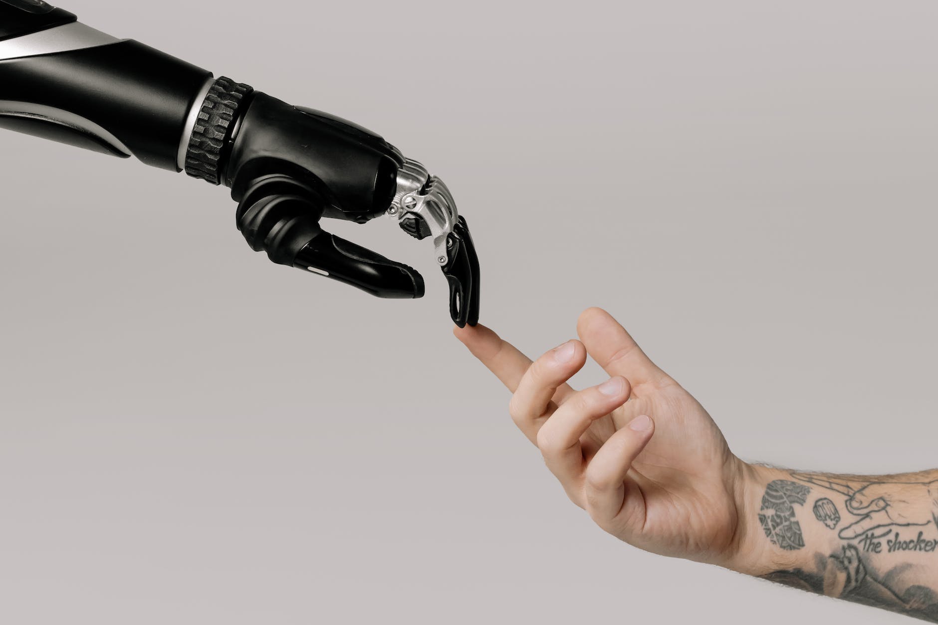 bionic hand and human hand finger pointing Artificial Intelligence (AI)